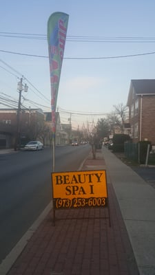 Sign right in front of salon....slow down and park in back