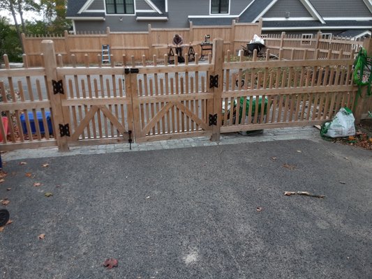 A stockade fence with gate.