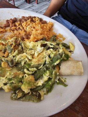 Eggs with cactus served with rice and beans.