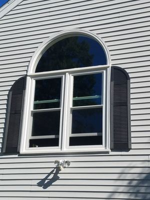 Soft lite vinyl replacement windows with new arch glass and exterior trim.