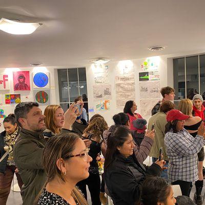 Parents taking photos from Fall Student Art Exhibition