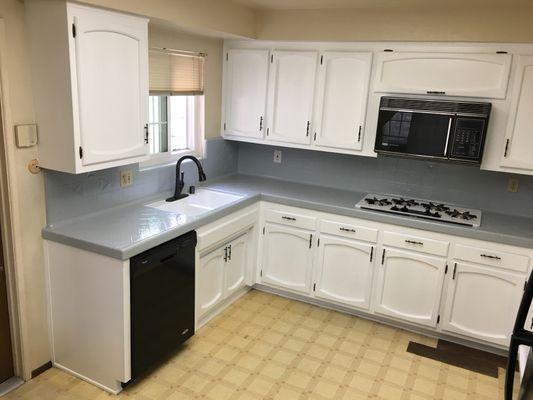 Tile countertop refinished gray along with satin finish on cabinets