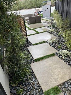 Concrete squares with turf and pebbles