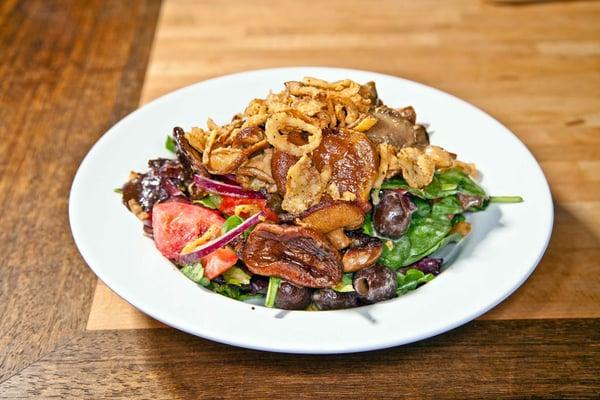 Sautéed seasonal mushrooms topped on mixed greens, black olives, red onions, bell peppers, tomatoes, and avocado. Tossed in special creamy-w