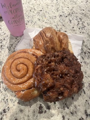 Apple fritter, cinnamon roll and croissant