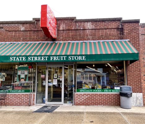 Storefront with iconic red sign and green awning