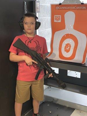 My sons first time, great grouping with the fully automatic MP5 9mm.