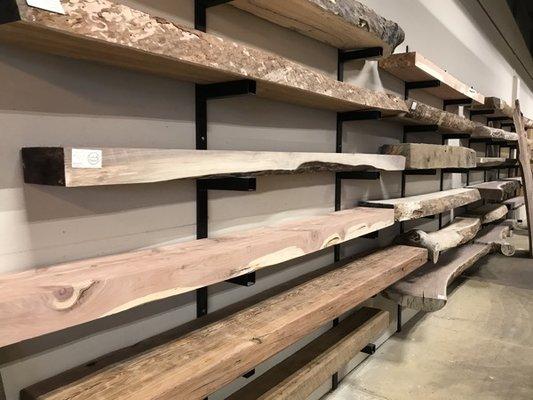 Selection of walnut, cherry, and more species of live edge mantels at the Leesburg store.