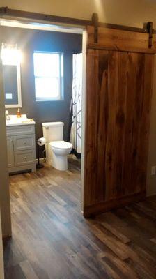 Completed vinyl flooring in bathroom and into the hall way.