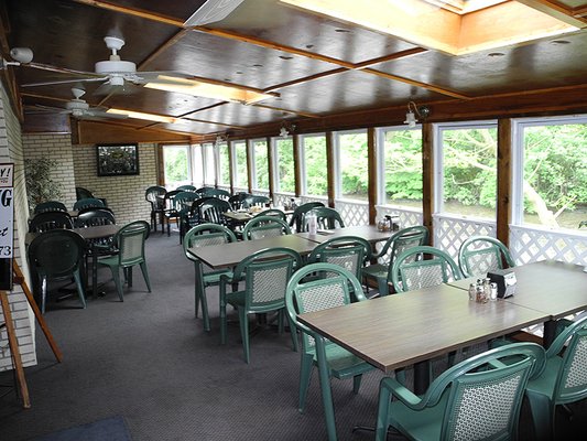 The Restaurant and Pizzeria at Domenico Pizzeria & Liquor Store is a sun-room situated on the banks of the Pequest River.