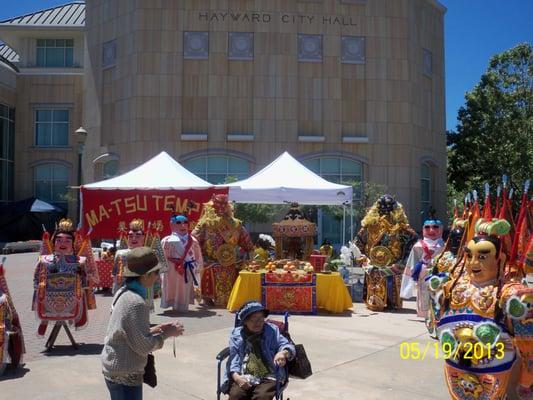 Some sort of asian sculpture/figure/(costume?) display.  I wonder if they're parts of costumes that stilt-walkers wear?