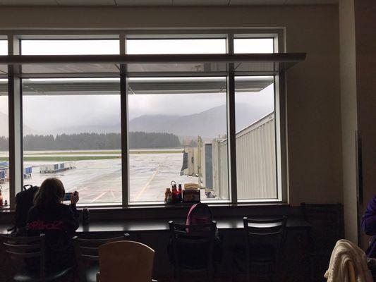 Seating next to gate by the window at Tailwind Concession