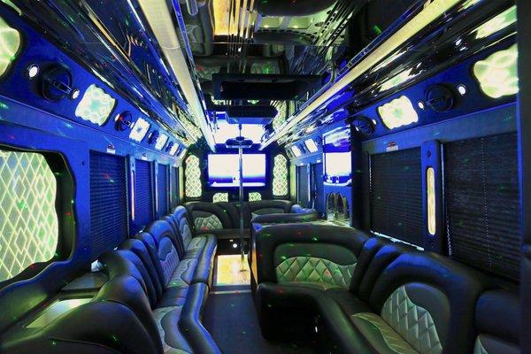 Our Rockstar Party Bus interior has 3 Flat Screen TV's, a large bar area, dance pole and luxury wrap around leather seating