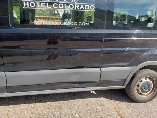 Before on a hotel shuttle van; driver's side door