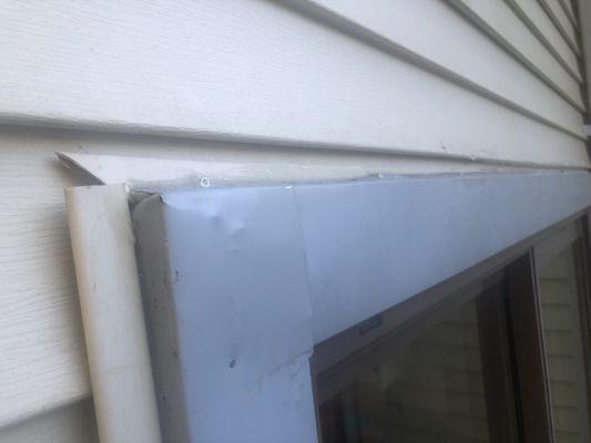 Does this look water tight to you, no.   The siding is open, doesn't even meet.   The capping is above where it's supposed to be.