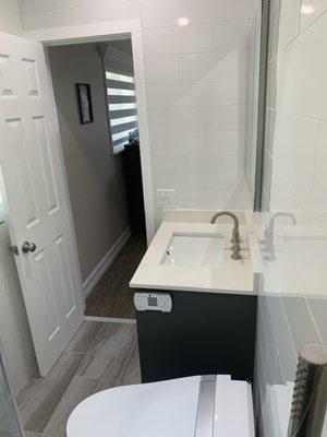 After. Recessed electronic medicine cabinet. Electronic bidet toilet. Vanity with quartz top.