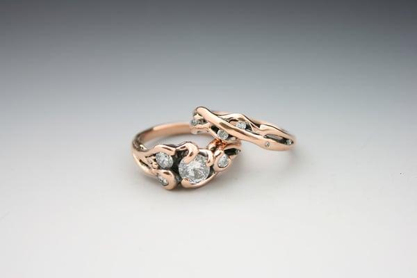 Eleanor's repurposed rings, commissioned from out-of-state. The completed set is a stunning design of diamonds surrounding in 14k rose gold.