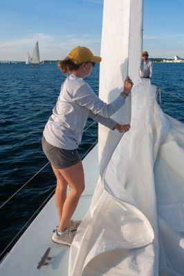 Flaking sail on way in to harbor