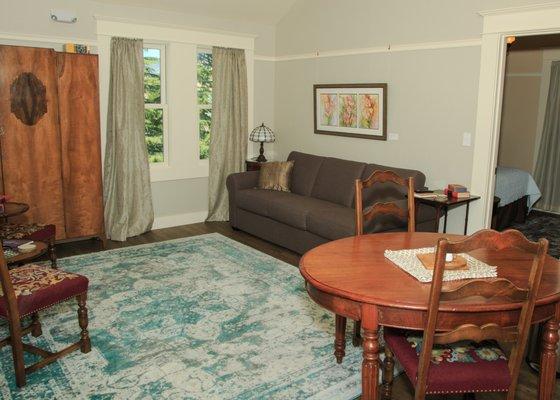 The two bedroom suite has a large living room and dining room area in an open floor plan flanked by the cozy farmhouse kitchen.