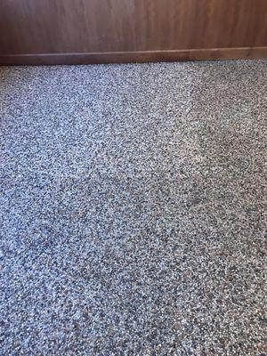 This is some pebble flooring recently cleaned in a restaurant. The picture shows a stark contrast in the square area that was cleaned.