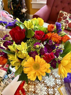 The colors in this floral arrangement can only make someone smile. the flowers are all fresh. I love it.