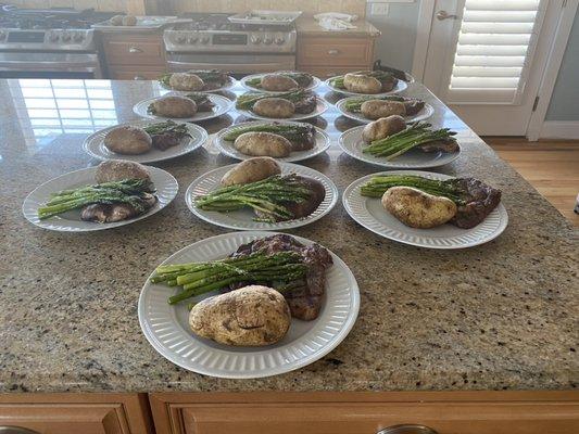 Hand cut Ribeye steak baked potato and asparagus for a party of 13