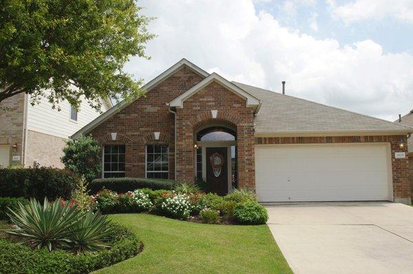 Beautiful landscaping highlights this well maintained home in the Cat Hollow subdivision in the Round Rock area.