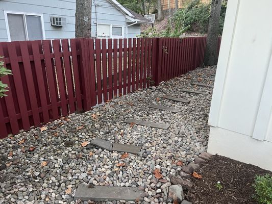 spaced stained red wood fence