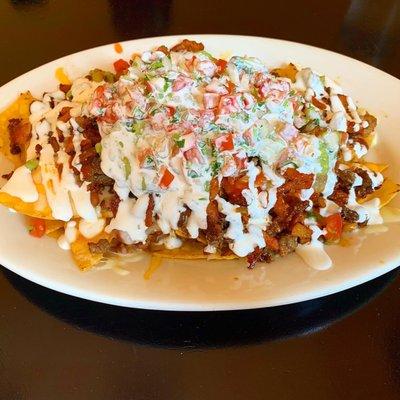 Fully loaded nachos with half Al Pastor and Carne Asada