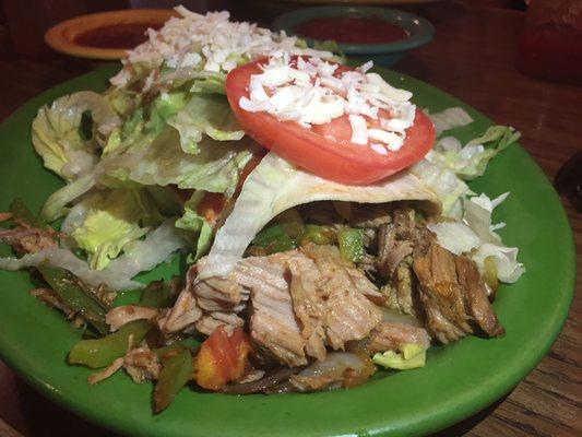 The pork burrito with sautéed onions & peppers then topped with guacamole, sour cream, lettuce, tomato & cheese rocks.