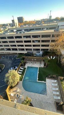 Daytime view of the pool and parking garage.