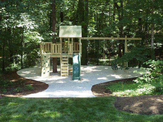 5x5 Fort with a tree porch, rock wall, angled steps, slide and 4 swing positions!    Customer added the pea gravel which turned out great.