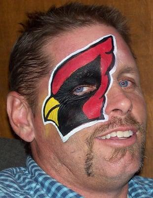 AZ Cardinal eye design painted by face painter Nancy Kartoon.