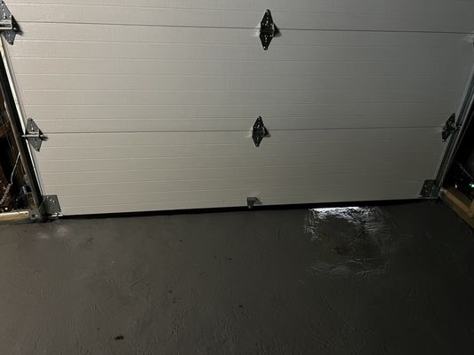 Daylight visible, and water coming in, below garage door.