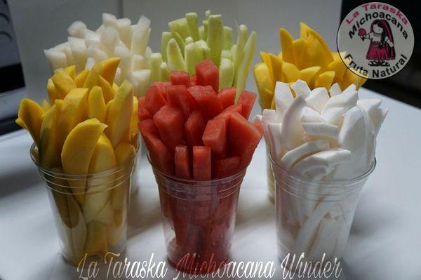 Cups of fruits Mango cucumbers watermelon jicama and coconut