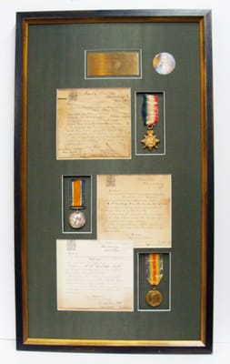 Framed shadow box with medals and documents