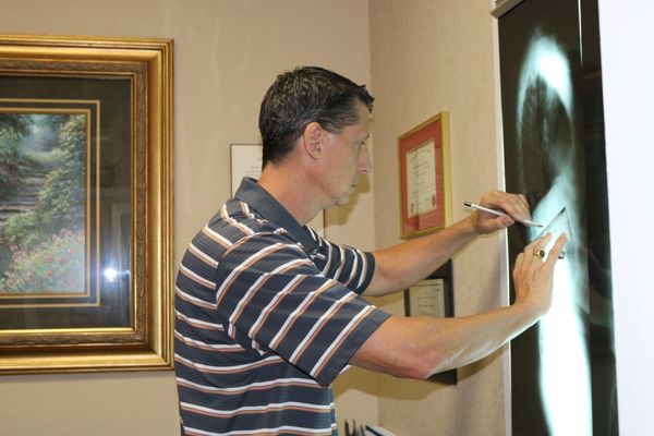 Dr. Hastings marking and measuring xrays