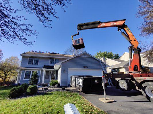 Shingles being delivered right to the top of our customers home.