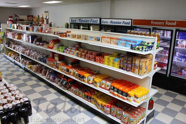 Full aisle view of the section with porridge ( , that is semolina, and  , that is buckwheat), cookies and sweets.