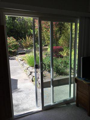 Looking out of the sliding glass door into the back patio yard.