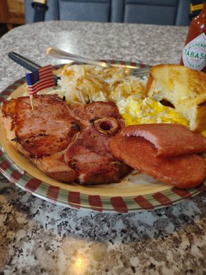 Frank's breakfast So delicious huge tender pork chop some fried spam hash browns and a tasty piece of bread