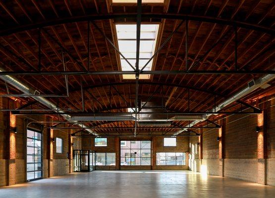 A wide, open space with a large skylight and industrial features.