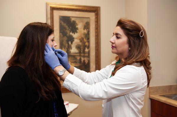 Dr. Chaudhary performing Botox on a patient.