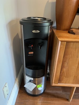 Empty water cooler gathering dust, waiting for a delivery.