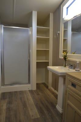 Rudy turned a useless space into a linen cabinet and added trim to an existing mirror.  He installed this vinyl plank flooring.