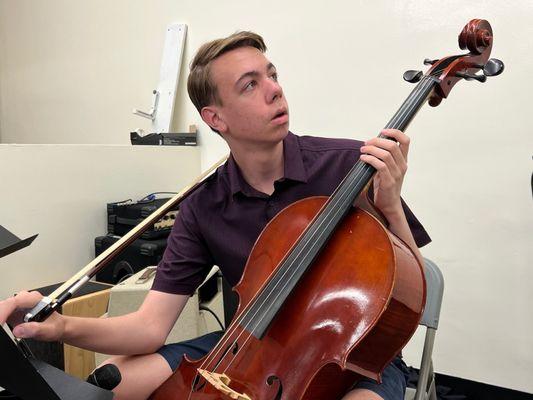 A cellist and member of Living Hope rehearses before worship