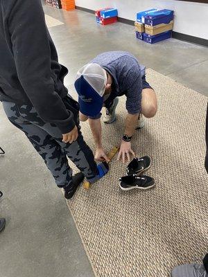 Employee helping us with getting spikes for my oldest son