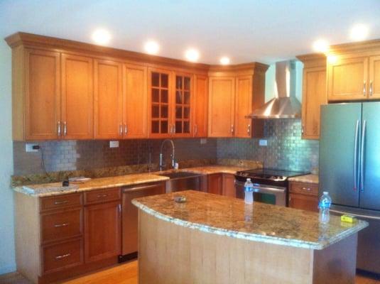 L shaped kitchen with barn sink, island, range , hood, dishwasher, fridge,  stainless steel mosiac subway tiles...