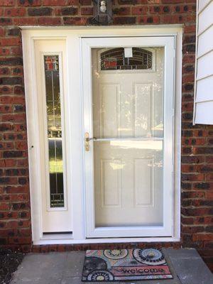 New entry door with sidelight and storm door installed