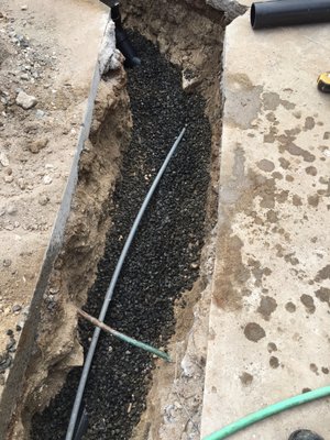 Continue sewer line repair with 100% compaction on repaired section of sewer line in driveway area